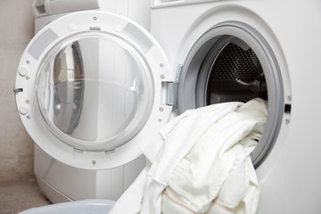 Dirty clothes in a washing machine - 54090866
