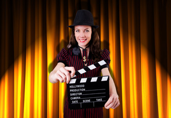 Woman gangster with movie clapper