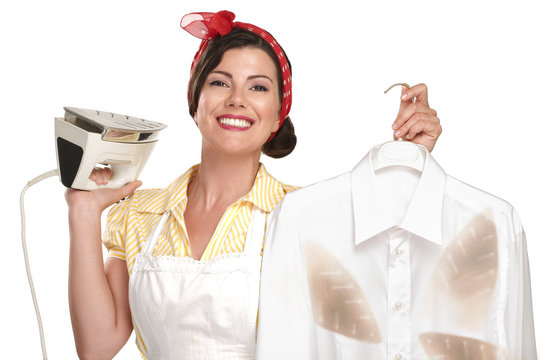 happy beautiful woman housewife ironing a shirt