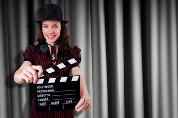Woman gangster with movie clapper