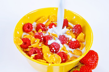 bowl of cereal flakes, raspberries and milk