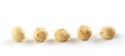 Closeup view of hazelnuts over white background