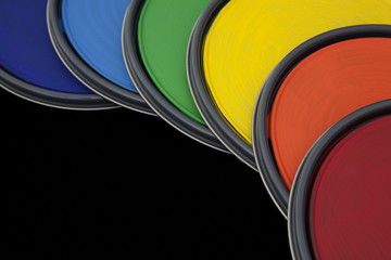 paint can lids with rainbow colored paint