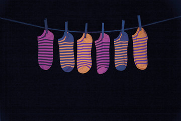 Black light photo of fluorescent striped socks