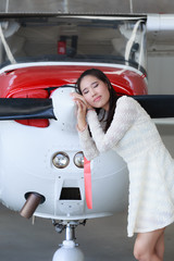 Woman standing in front of a light aircraft