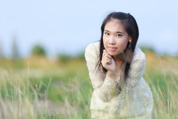 Beautiful Asian woman enjoy nature meadow.