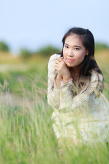 Beautiful Asian woman enjoy nature meadow.