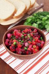 Beet salad in bowl on table close-up