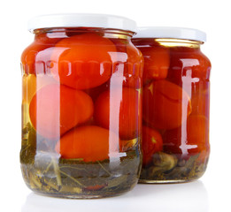 Tasty canned tomatoes in glass jars, isolated on white