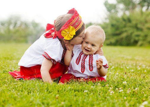 Two happy children in  folk clothes   in summer