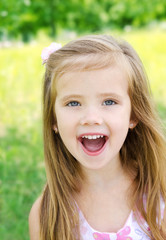 Portrait of screaming little girl in a meadow