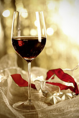 Glass of Red Wine and Christmas Ornaments