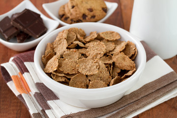cereals in white bowl and chocolate