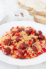 rice with sausages and red pepper on the plate