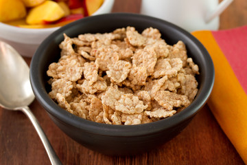 cereals in black bowl with fruits