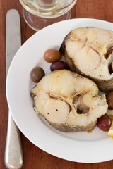 boiled fish with lemon and olives