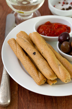 bread stick with sauce and olives