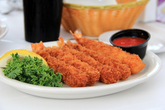 Jumbo Fried Shrimp And Cocktail Sauce On White Plate