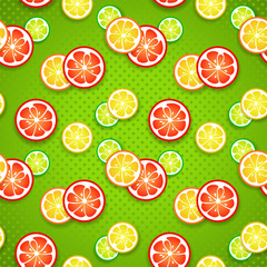 Slices of fresh citrus fruits on green polka dot background.