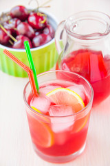 Delicious sweet berry juice of cherry in glass and carafe