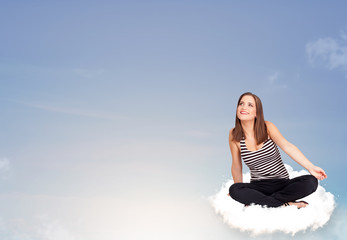 Young woman sitting on cloud with copy space