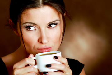 Woman with an aromatic coffee in hands