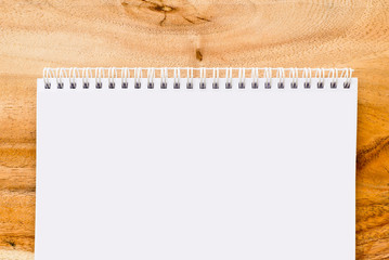 Open blank notebook on wood background