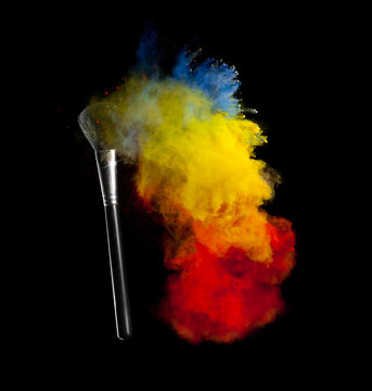 Colored powder with brush, isolated on black background