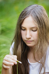 teenage girl wonders on flower