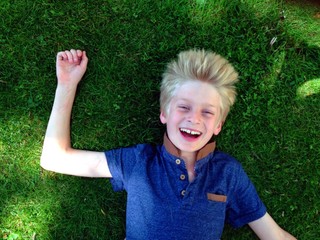 boy lying on grass