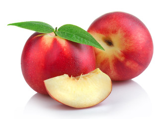 Ripe peach (nectarine) fruits with slices isolated