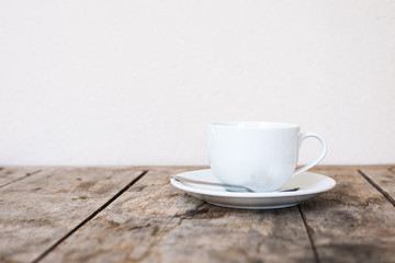 White cup on wood table.
