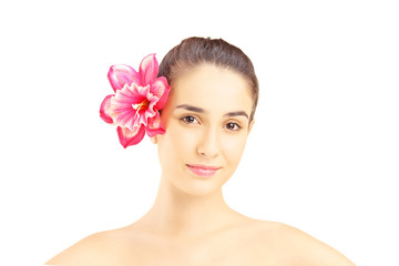 Portrait of young beautiful woman with flower in her hair