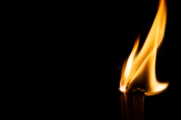 Burning match on a black background
