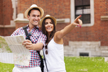 Woman pointing at something to her boyfriend during sightseeing