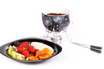 Chocolate fondue with fruits isolated on white