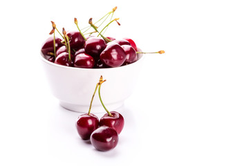 Sweet fresh cherry in a bowl isolated