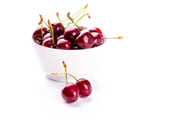 Sweet fresh cherry in a bowl isolated