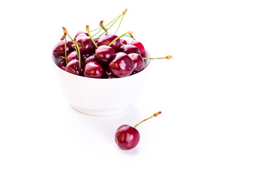Sweet fresh cherry in a bowl isolated