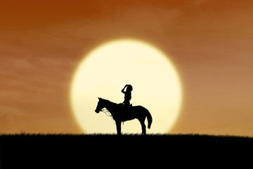Horse rider silhouette at sunset © Creativa Images