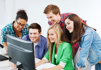 students with computer studying at school