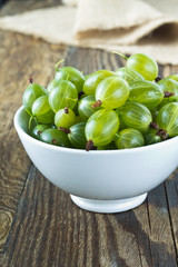 Green gooseberries in a white bowl