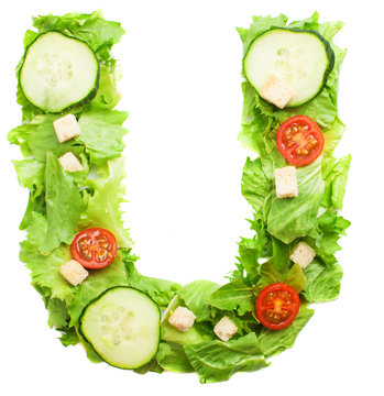 U letter made with salad isolated on white
