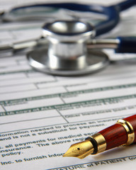 Stethoscope on medical billing statement on table