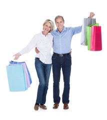 Mature Couple Holding Shopping Bags