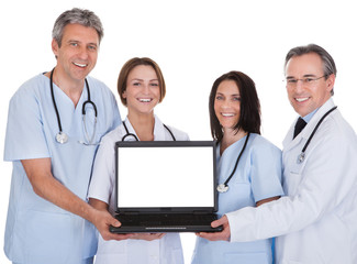 Group Of Doctors With A Laptop