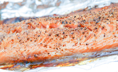 Obraz na płótnie Canvas Grilled salmon in aluminum towards white