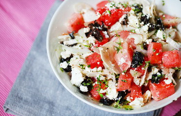 Watermelon salad with feta cheese, olives, onion and thyme