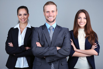 Business team standing in row on grey background