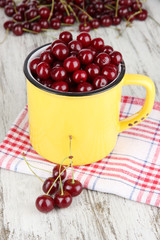 Sweet cherry in cup on table close-up